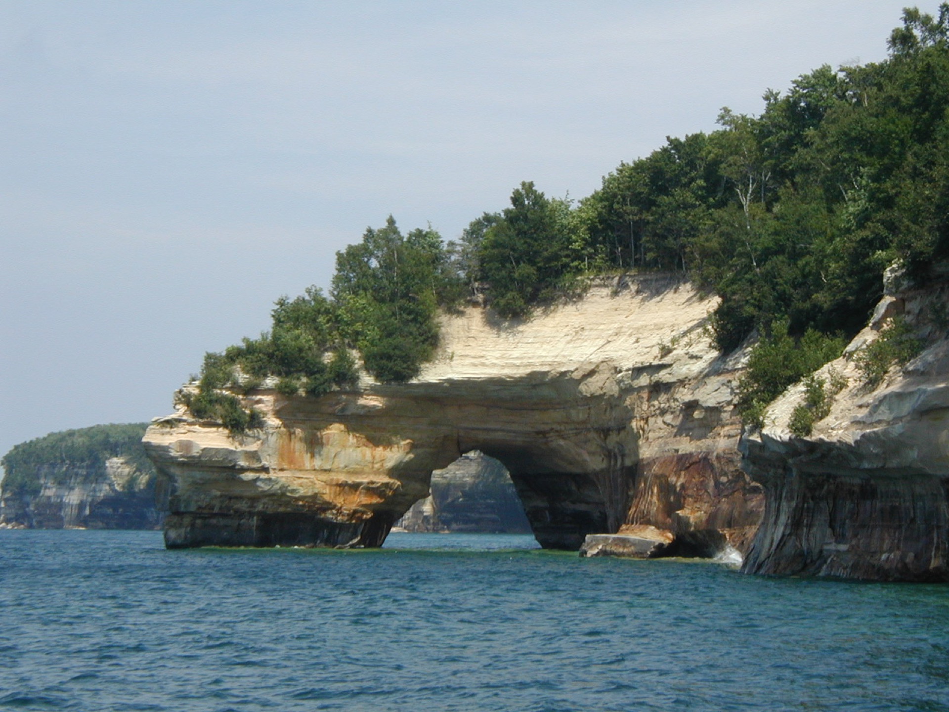 Sandstone cliffs and turquoise water along the Great Lakes shoreline near campus